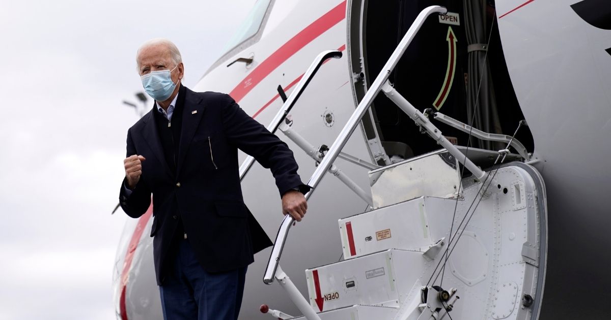 Presumed president-elect Joe Biden departs his plane after arriving at Hartsfield-Jackson Atlanta International Airport before attending a drive-in rally for U.S. Senate candidates Jon Ossoff and Rev. Raphael Warnock at Pullman Yard on Tuesday in Atlanta.