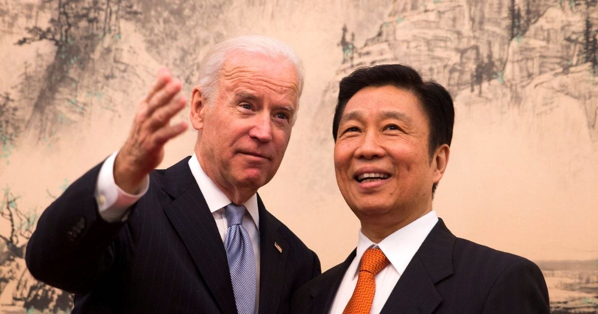Then-Vice President Joe Biden, left, chats with his Chinese counterpart, Li Yuanchao, before heading to a luncheon at the Diaoyutai State Guesthouse in Beijing on Dec. 5, 2013.