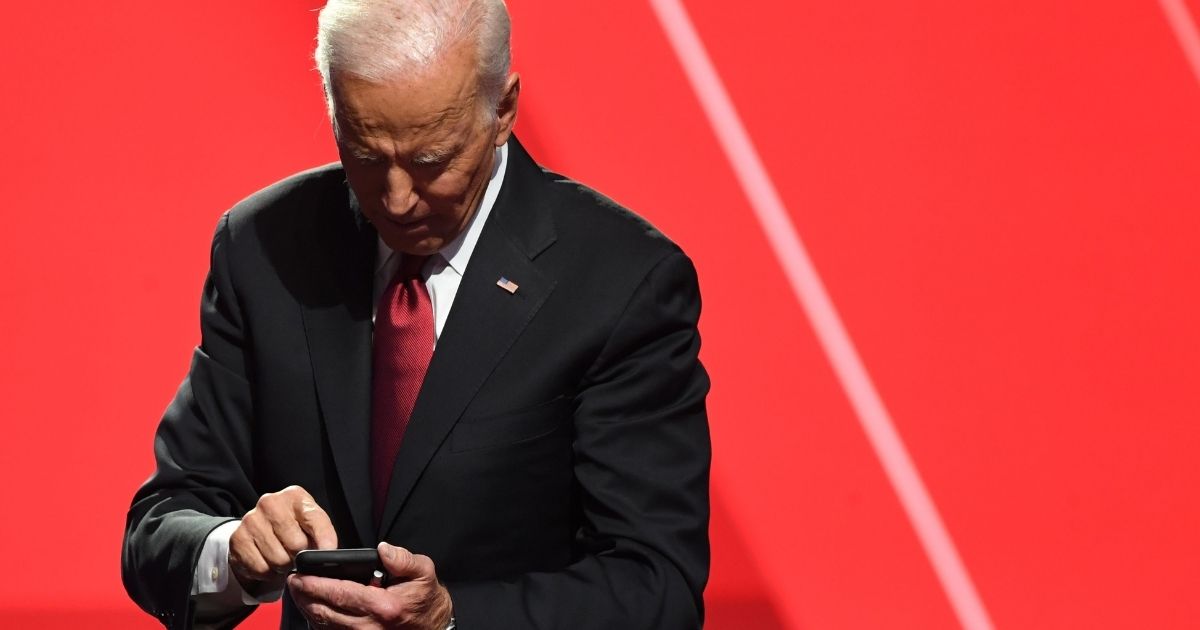 Former Vice President Joe Biden looks at his phone after the fourth Democratic primary debate of the 2020 presidential campaign season co-hosted by The New York Times and CNN at Otterbein University in Westerville, Ohio, on Oct. 15, 2019.