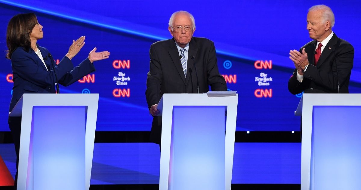 California Sen. Kamala Harris, left, Vermont Sen. Bernie Sanders and former Vice President Joe Biden, right, participate in the fourth Democratic primary debate of the 2020 presidential campaign season at Otterbein University in Westerville, Ohio, on Oct. 15, 2019.