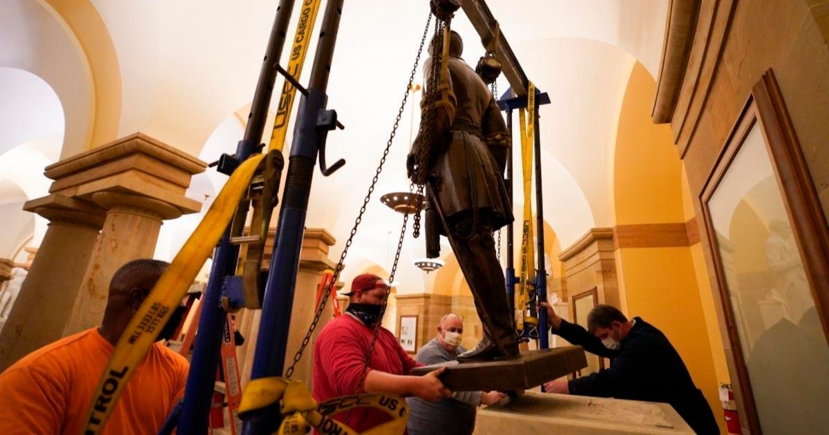 Workers remove a statue of Confederate Gen. Robert E. Lee from the National Statuary Hall Collection at the Capitol in Washington on Monday.