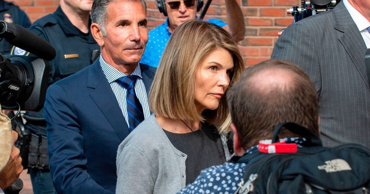 Actress Lori Loughlin and husband Mossimo Giannulli exit the Boston Federal Court house after a pre-trial hearing with Magistrate Judge Kelley at the John Joseph Moakley US Courthouse in Boston on Aug. 27, 2019.