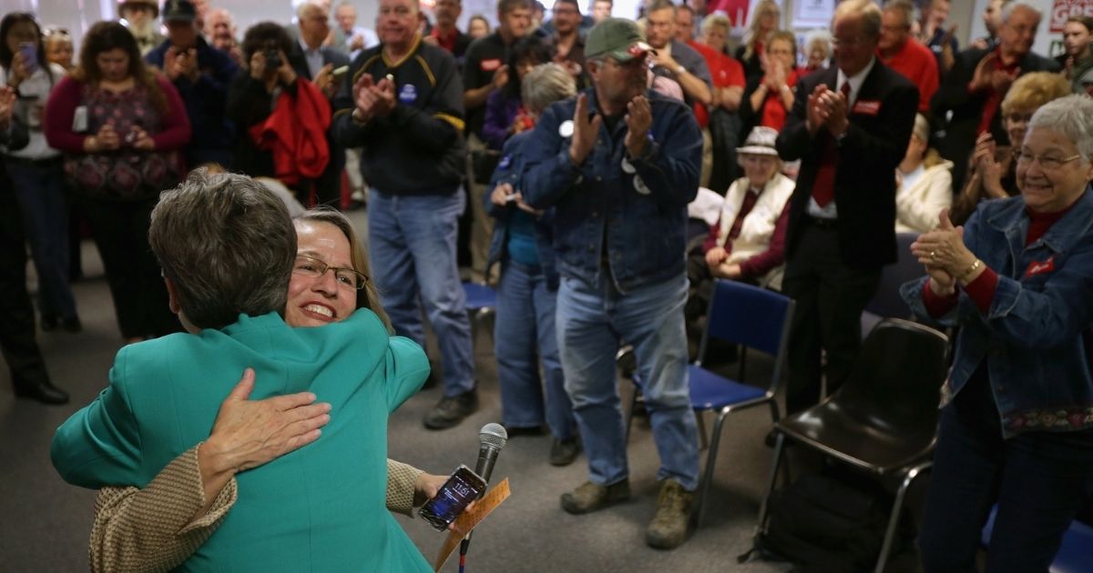 Then-Republican U.S. Senate candidate Joni Ernst, left, embraces then-House GOP candidate Mariannette Miller-Meeks during a rally at the Johnson County GOP Victory Office on Nov. 3, 2014, in Iowa City, Iowa.