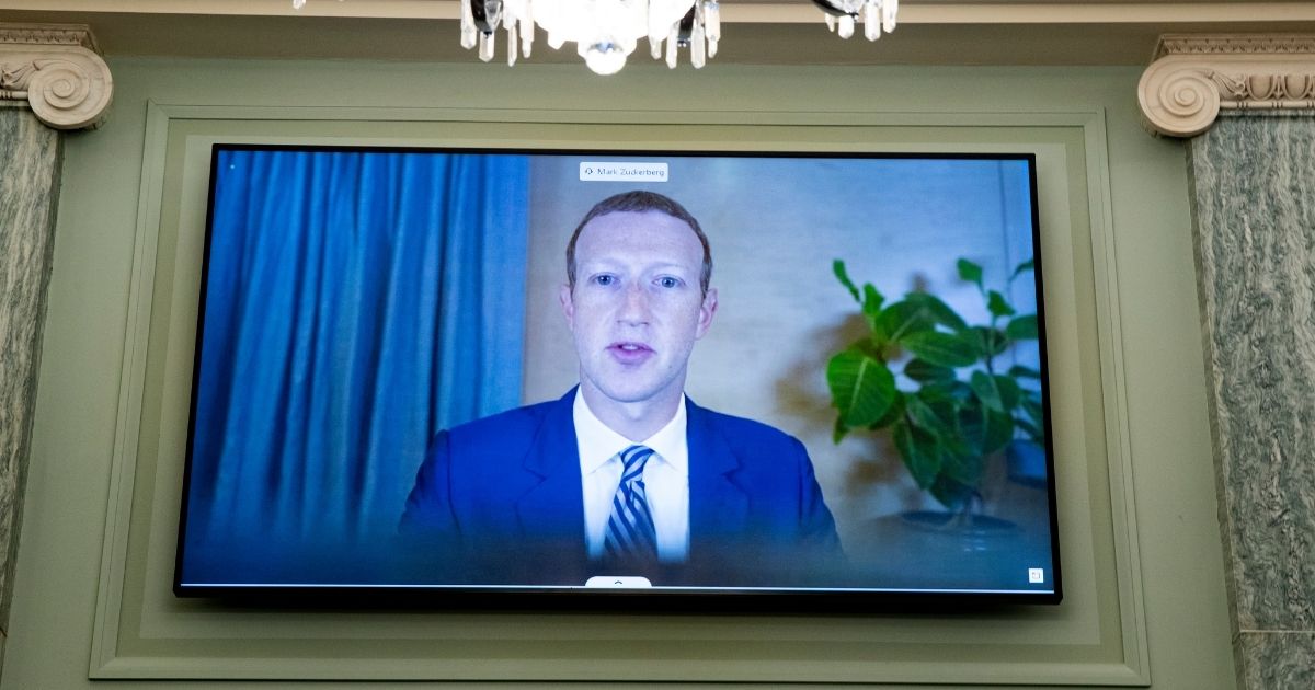 CEO of Facebook Mark Zuckerberg appears on a monitor as he testifies remotely during the Senate Commerce, Science, and Transportation Committee hearing on Oct. 28 in Washington D.C.