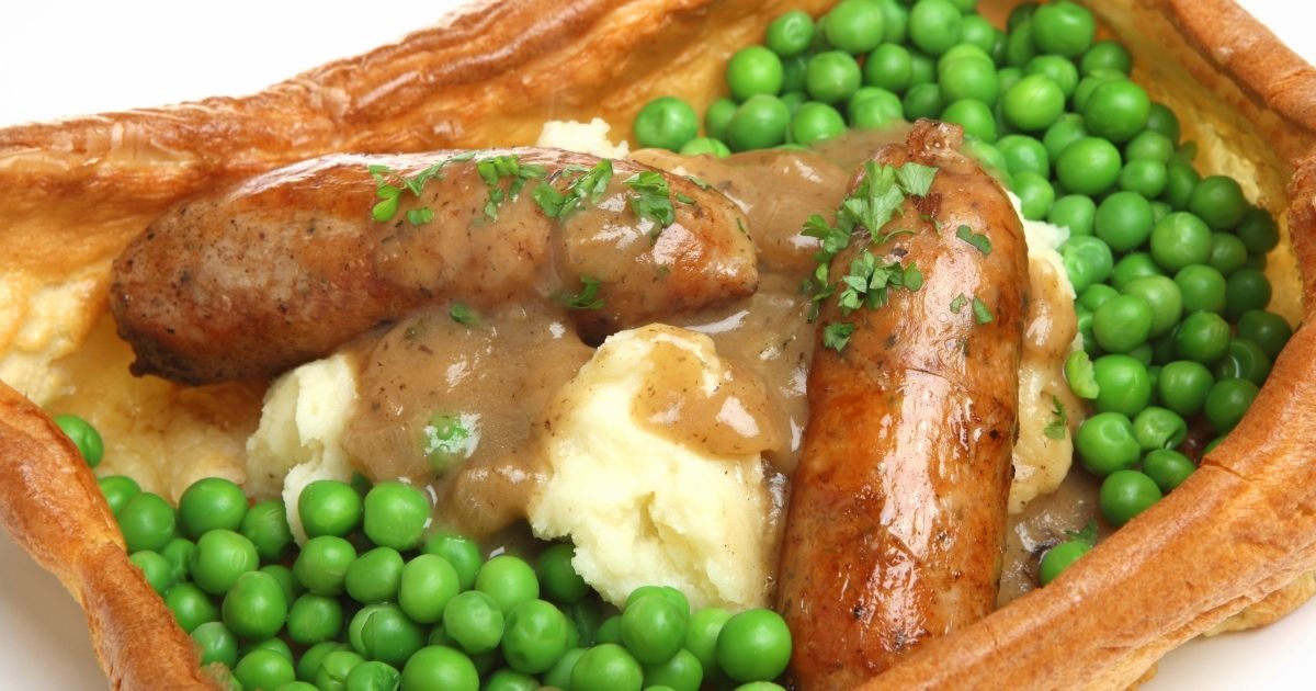 A meal consisting of mashed potatoes, sausages, peas and gravy in Yorkshire pudding is seen in the stock image above.