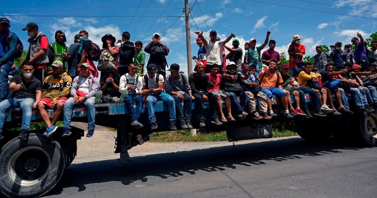 Honduran migrants, part of a caravan heading to the United States, are seen onboard a truck in Entre Rios, Guatemala, after crossing the border from Honduras on Oct. 1.