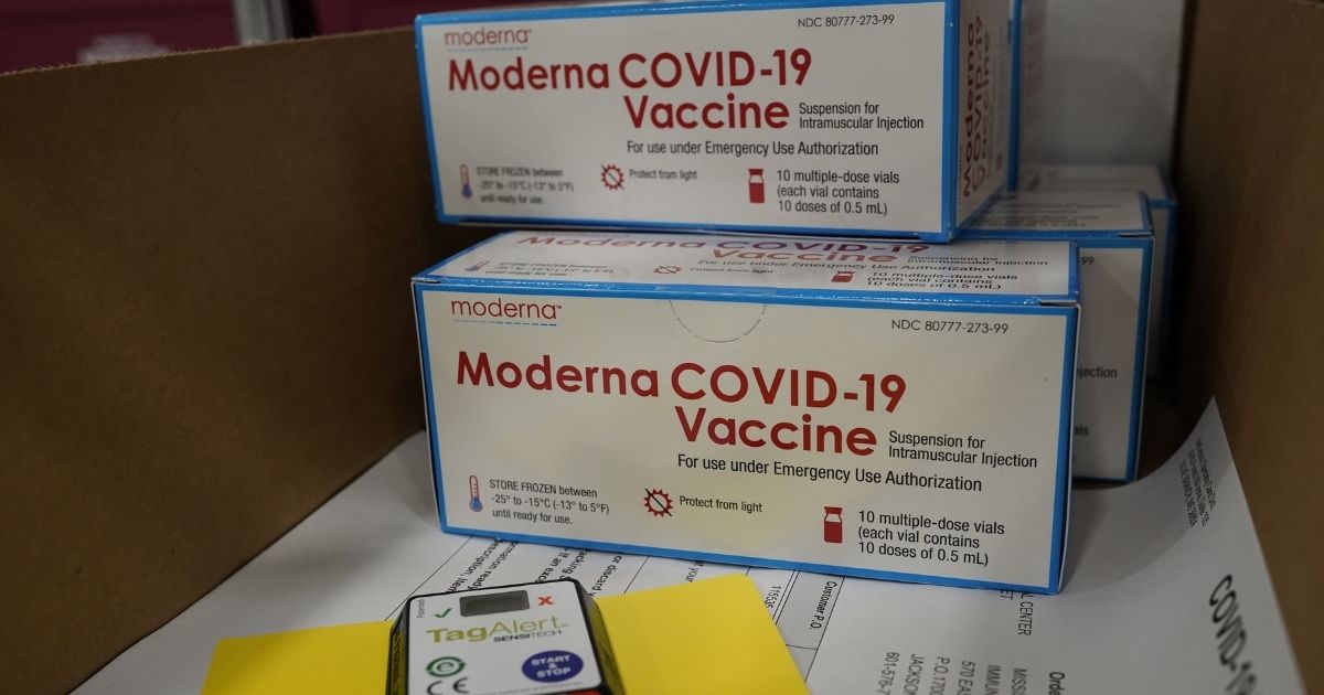 Boxes containing the Moderna COVID-19 vaccine are prepared to be shipped at the McKesson distribution center in Olive Branch, Mississippi.