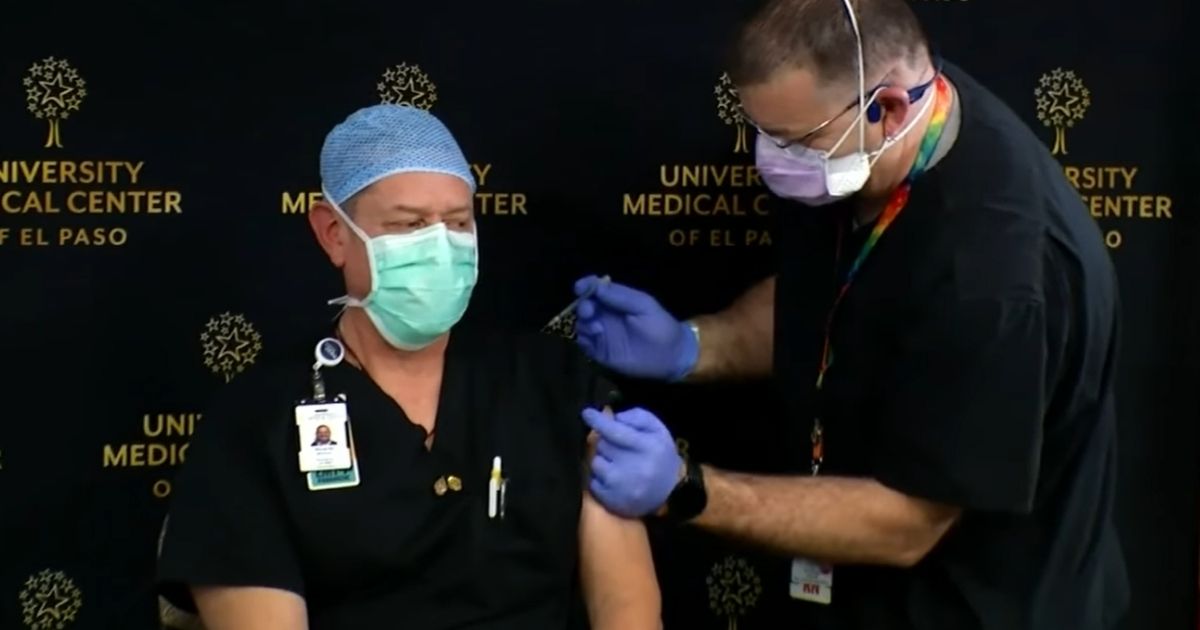 A nurse at the University of El Paso Medical Center receives what supposedly was a COVID-19 vaccine.