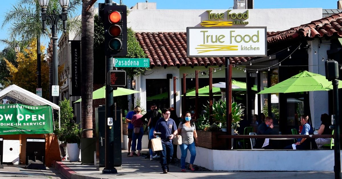 People dine outdoors in Pasadena, California, the only city in Los Angeles County still allowing that service, on Tuesday.