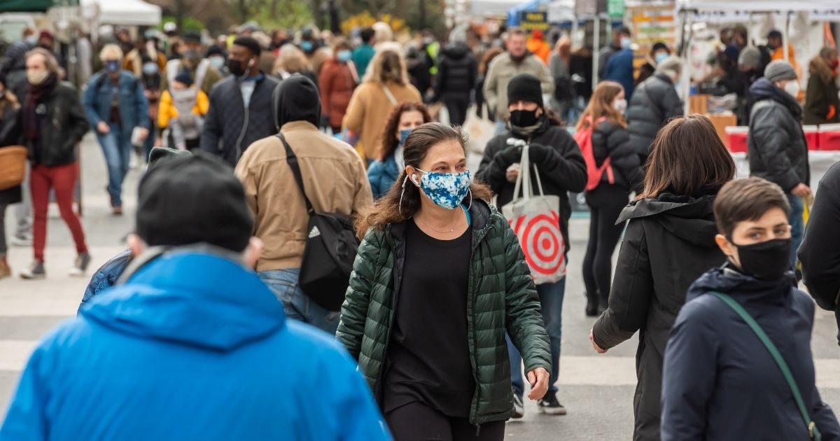 People wear protective face masks while shopping at the Union Square Greenmarket on Friday in New York City.