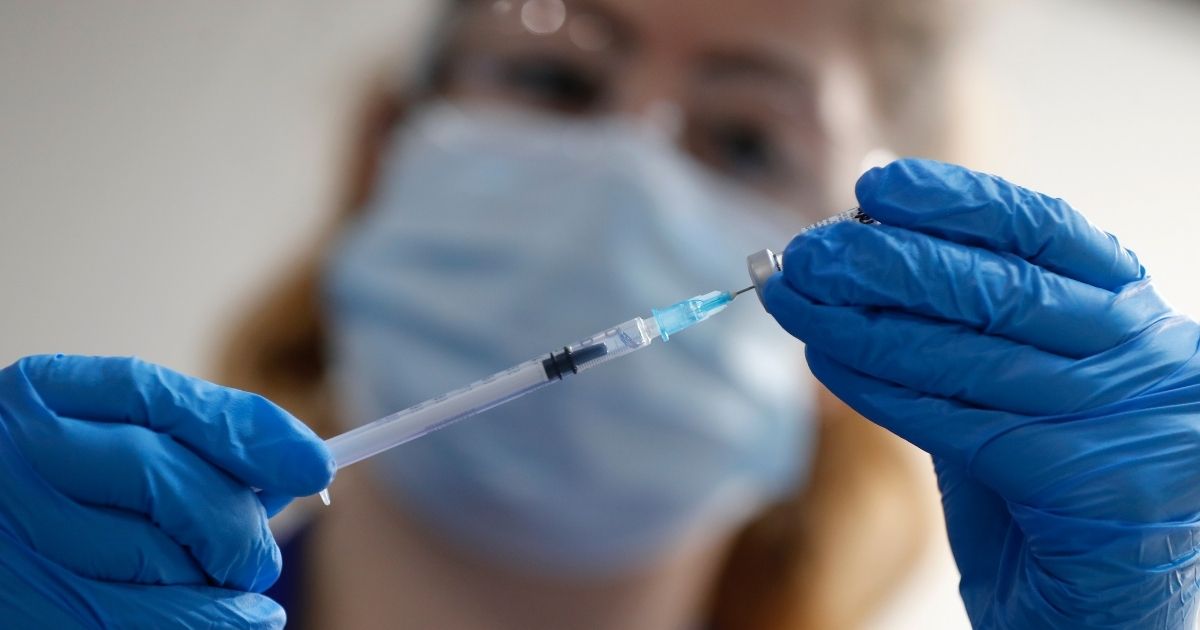 A nurse prepares a shot of the Pfizer-BioNTech COVID-19 vaccine at Guy's Hospital in London on Tuesday as the U.K. health authorities rolled out a national mass vaccination program.