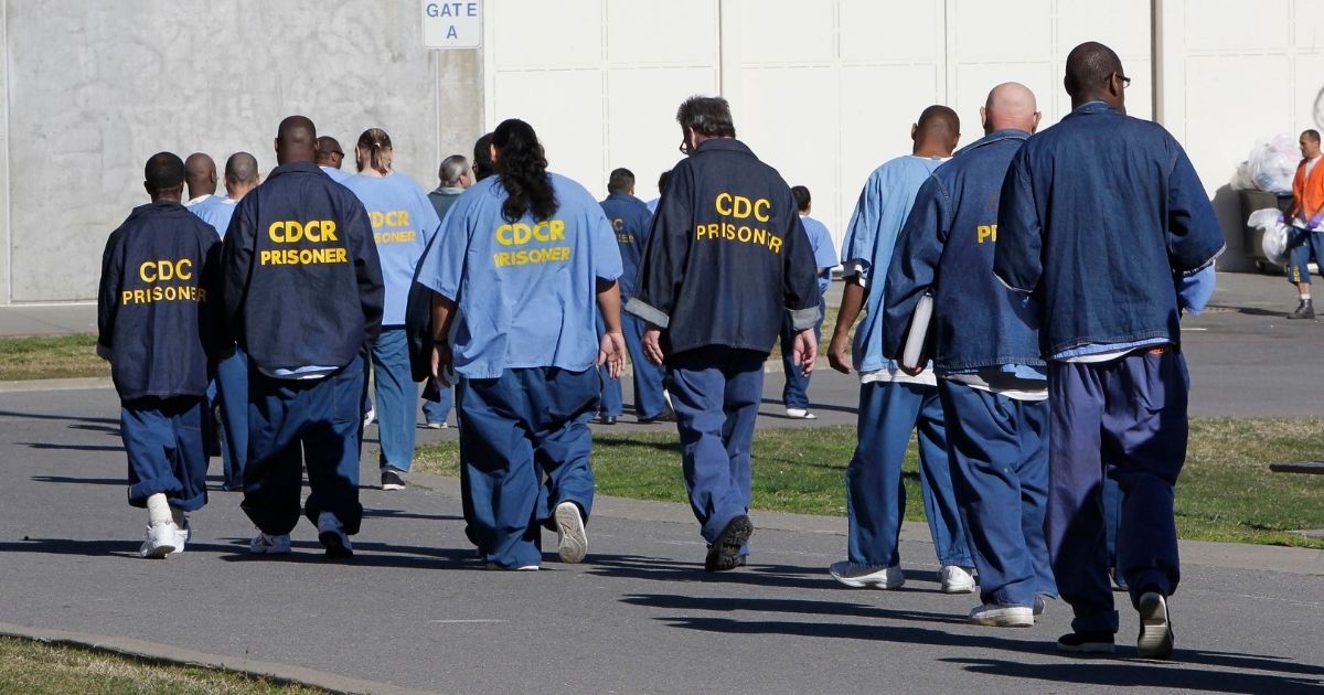 Inmates walk through the exercise yard at California State Prison Sacramento, near Folsom, on Feb. 26, 2013.