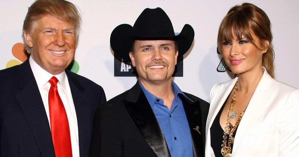 Country music star John Rich poses with Donald and Melania Trump at Trump SoHo in New York City on May 22, 2011.