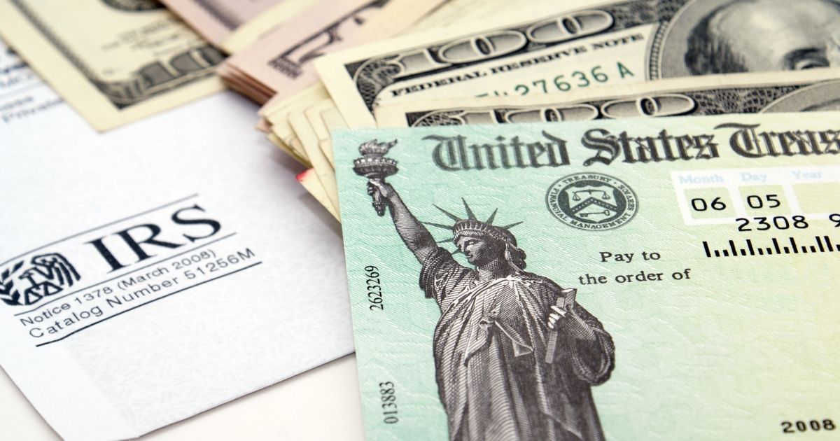 Stacks of bills and a tax return check are pictured in the stock image above.