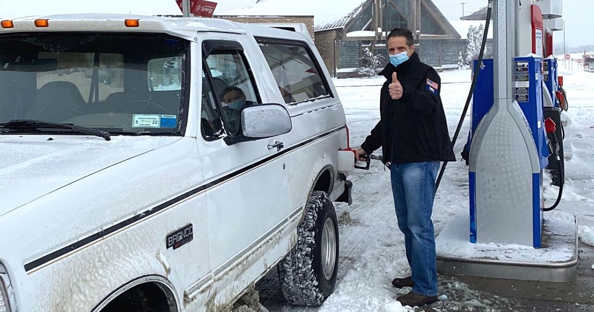 New York Governor Andrew Cuomo gasses up a Ford Bronco after a snowstorm.