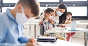 Students in a classroom with a teacher.