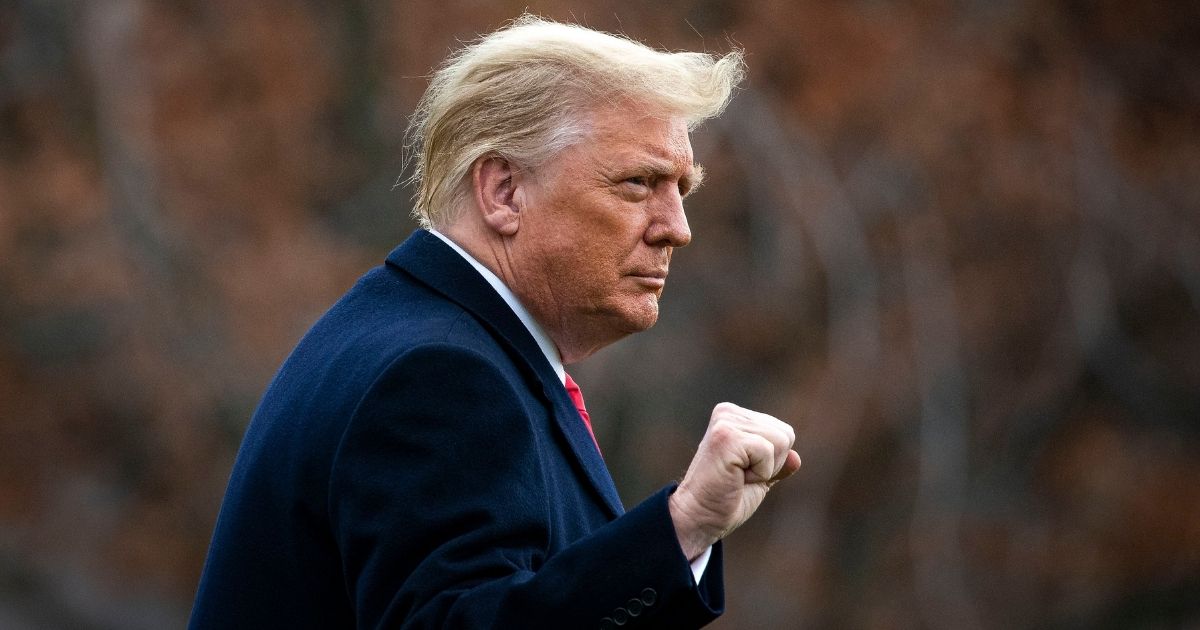 President Donald Trump pumps his fist as he departs on the South Lawn of the White House en route to the Dec. 12 Army-Navy game.