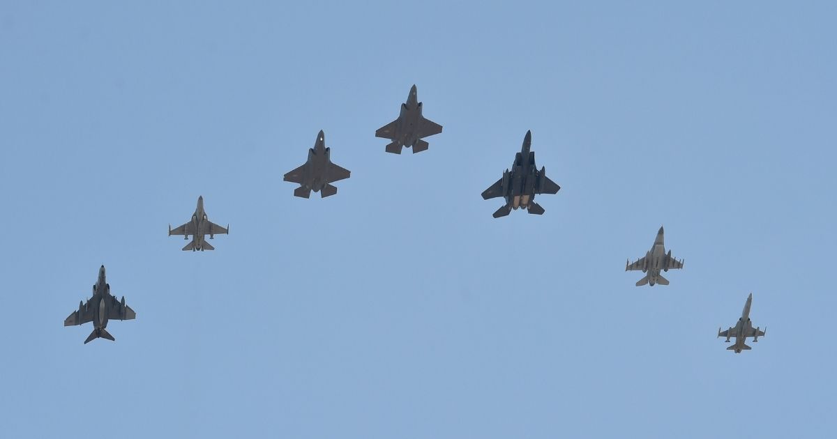 A formation of South Korean military aircraft flies over South Korea's Chogju Air Base two U.S. Air Force F-35A fighters, center and fifth from left, in a file photo from March 2019.