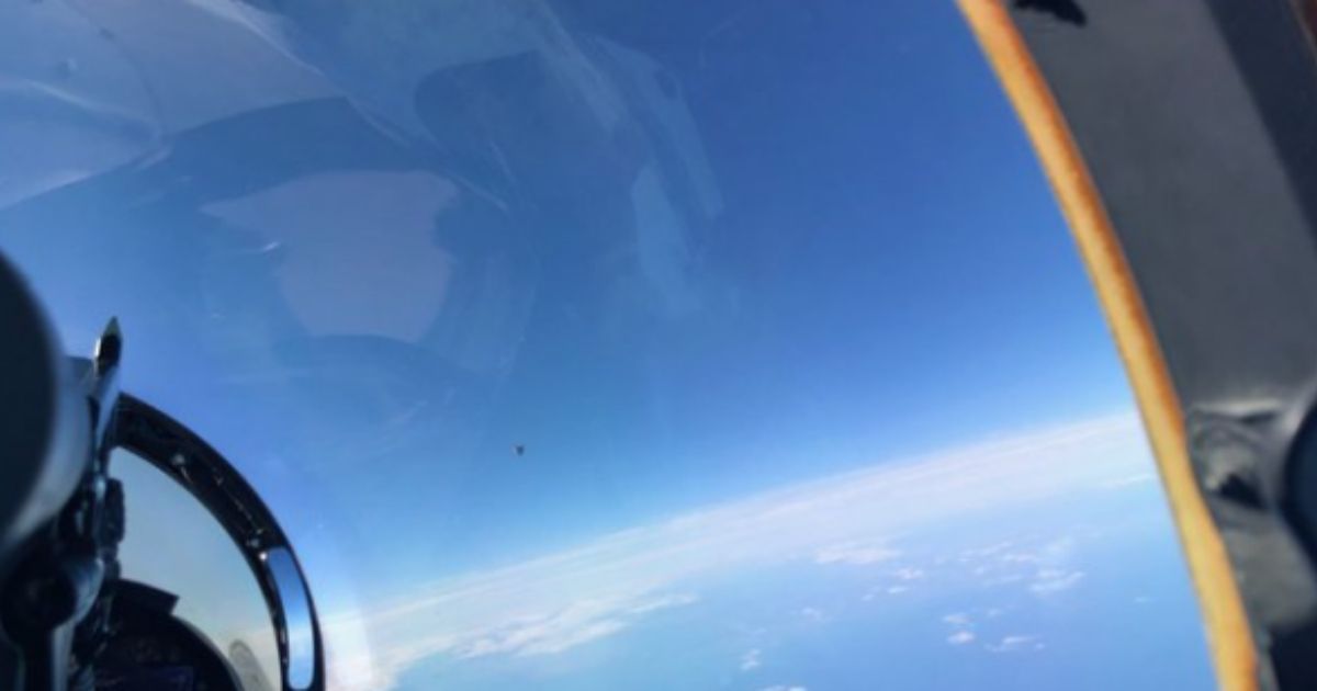 This photo, taken from an F/A-18 fighter jet, purportedly shows Unidentified Aerial Phenomena hovering over the ocean. The object is near the lower middle of the picture.
