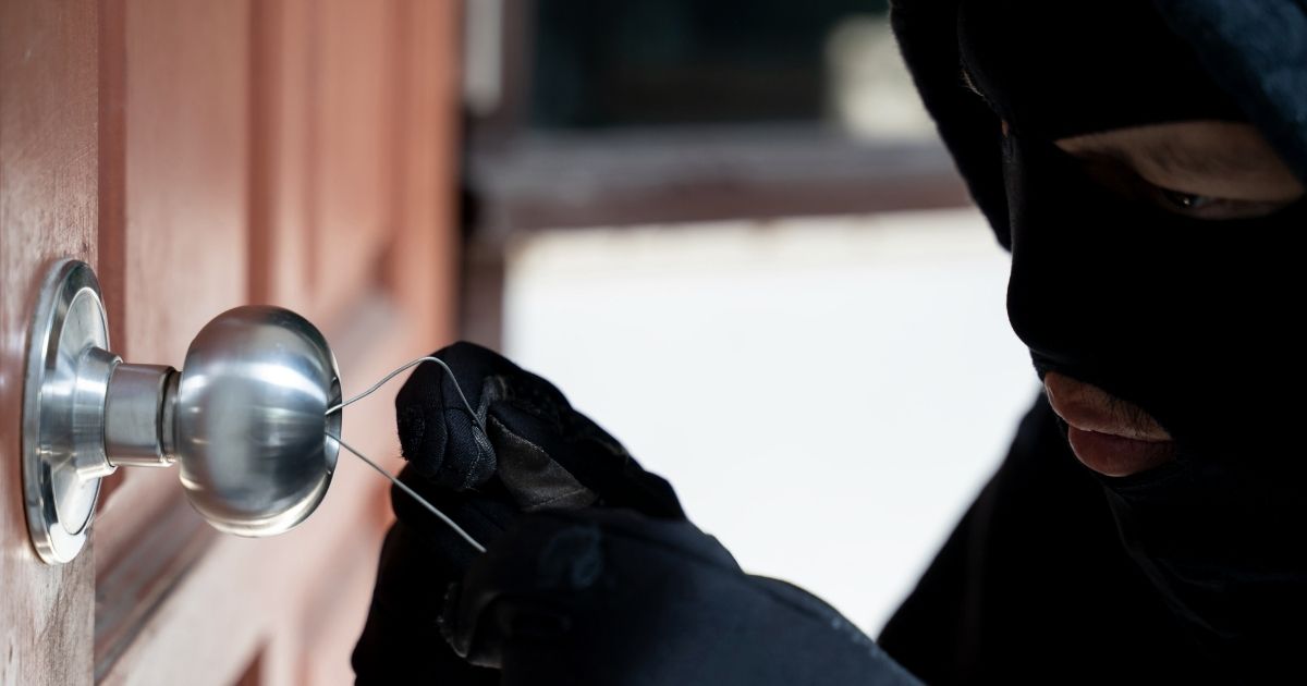 In this stock photo, a burglar starts to break into a house. In Louisiana, four suspects invaded a home on Dec. 8, 2020, and were shot by the homeowner. Two of the suspects died.