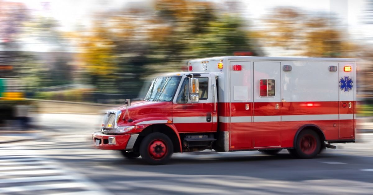 An ambulance travels on a city street in this stock photo. In Pine Bluff, Arkansas, two paramedics were shot after responding to a call on Dec. 17, 2020. Both reportedly underwent surgery and were in stable condition as of Dec. 20.