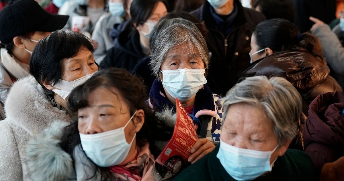 Residents wear masks while lined up for tea on Dec. 11, 2020, in Wuhan, Hubei Province, China.