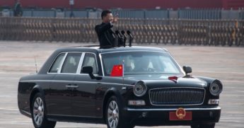 Chinese President Xi Jinping waves as he drives after inspecting the troops during a parade to celebrate the 70th Anniversary of the founding of the People's Republic of China at Tiananmen Square in 1949, on Oct. 1, 2019, in Beijing, China.