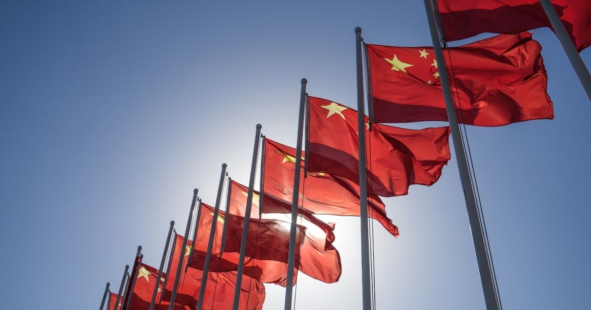 Chinese flags fly in the above stock image.