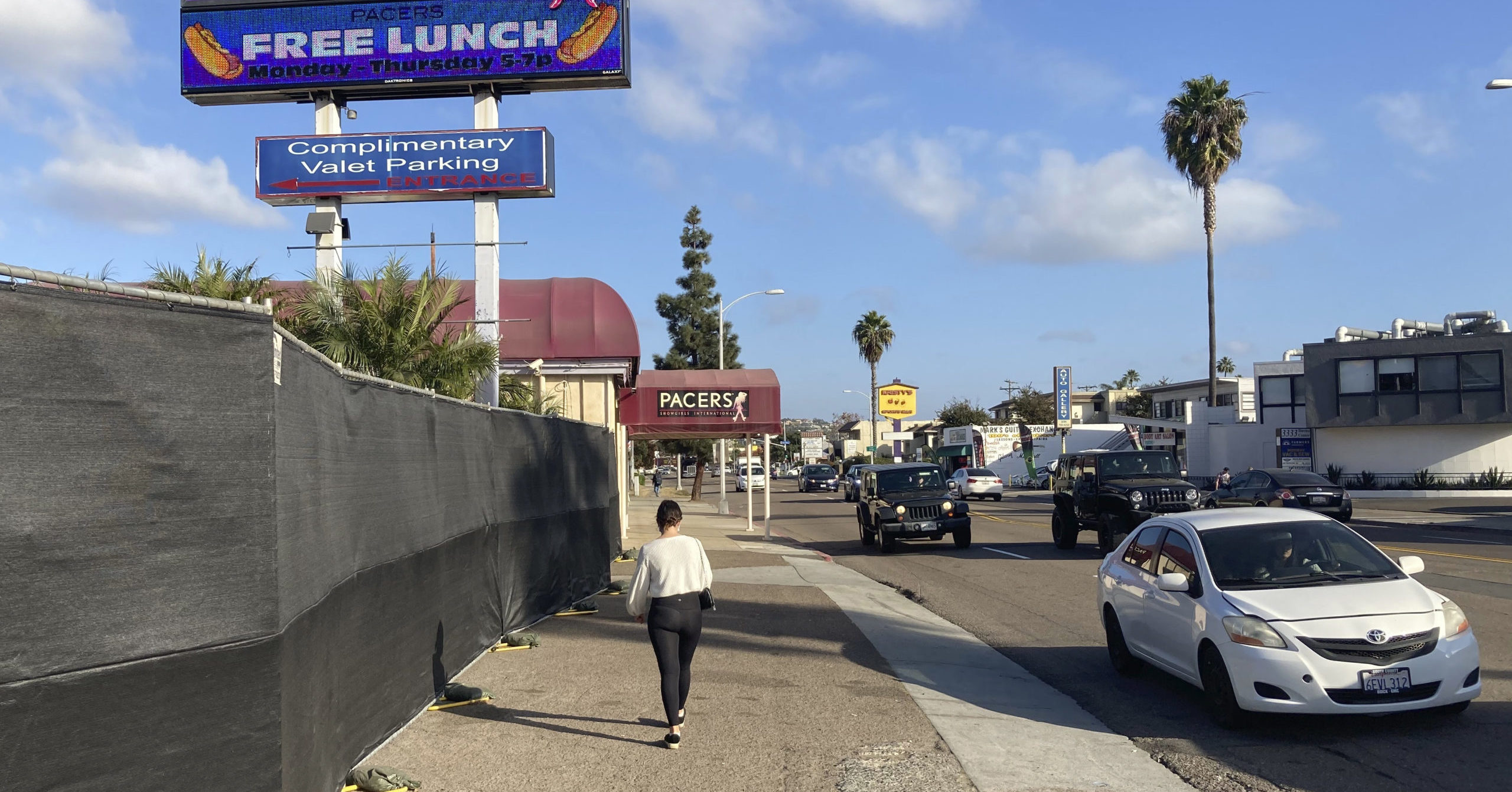 In this Dec. 10, 2020, file photo, a person walks past Pacers Showgirls International in San Diego.