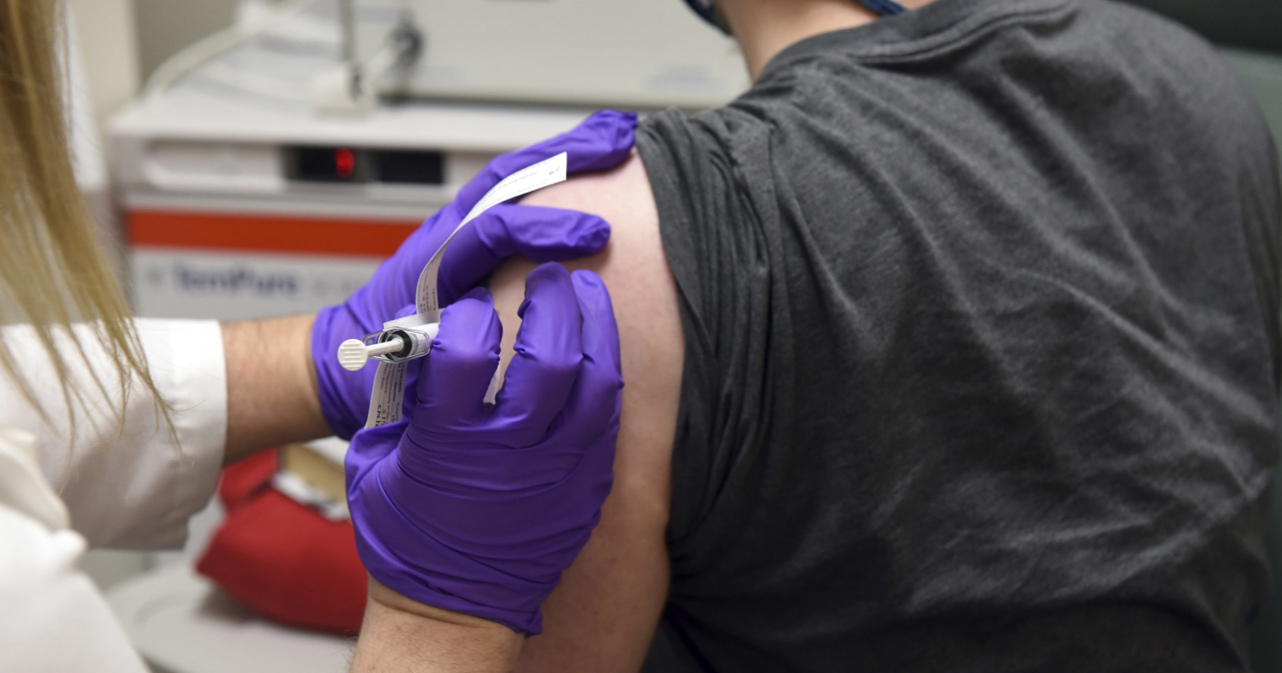 This May 4, 2020, file photo shows a patient receiving Pfizer's COVID-19 vaccine in a clinical trial at the University of Maryland School of Medicine in Baltimore.