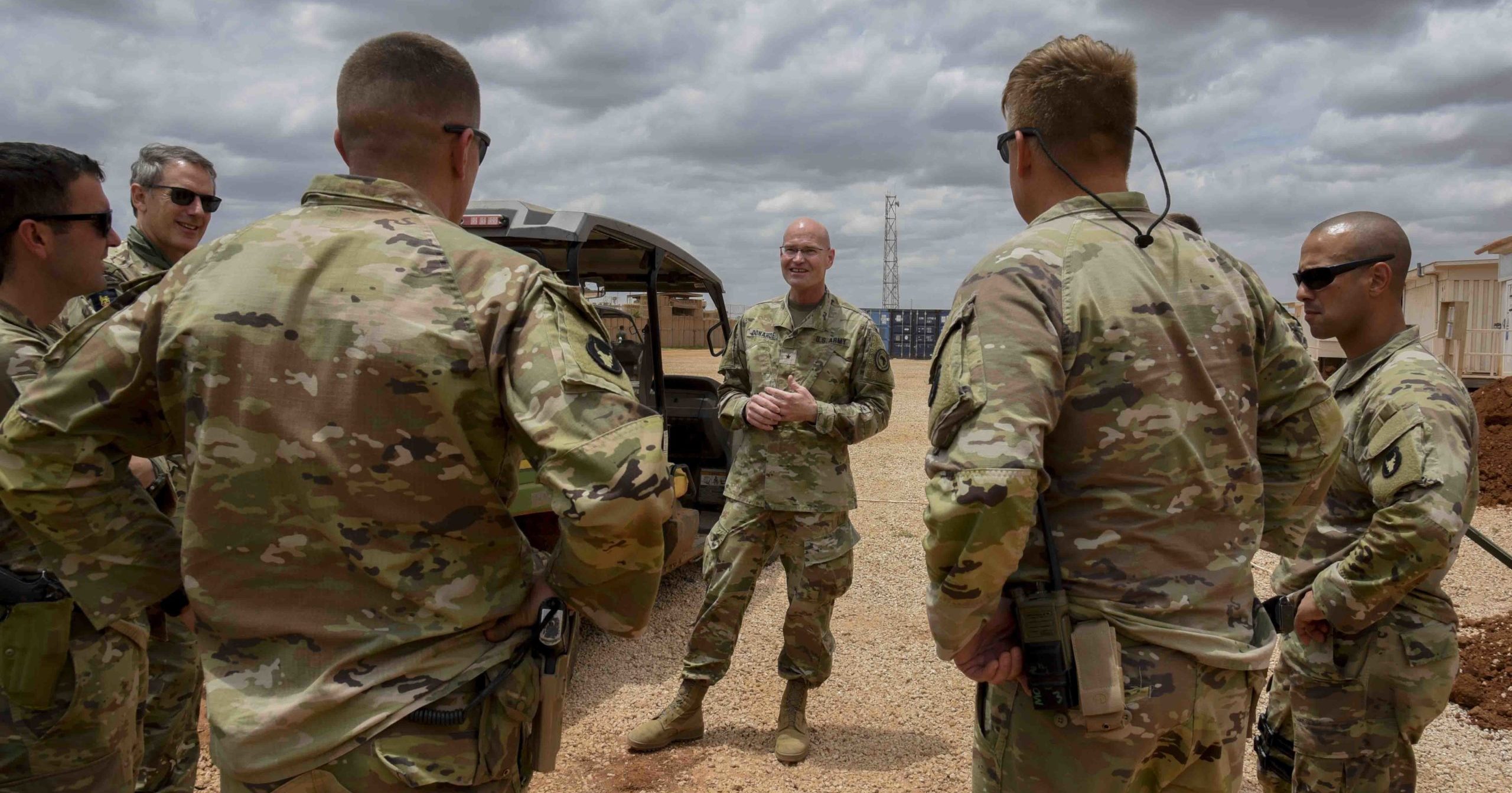 U.S. Army Brig. Gen. Damian T. Donahoe, center, talks with service members on Sept. 5, 2020, in Somalia.