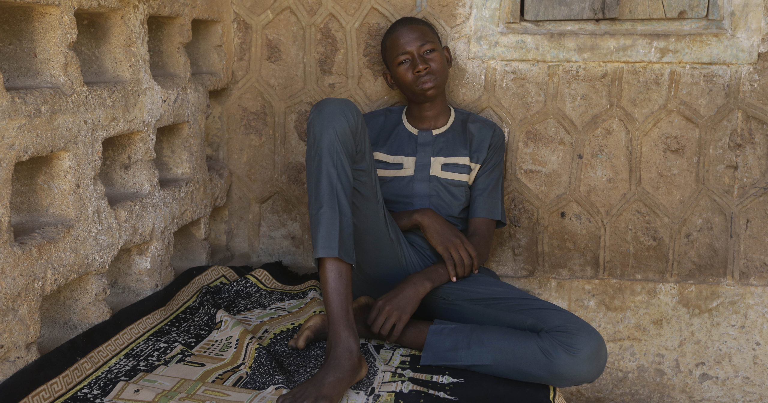 Usama Aminu, a 17-year-old student of the Government Science Secondary School who escaped from Boko Haram insurgents, sits for an interview with The Associated Press in Kankara, Nigeria, on Dec. 16, 2020.