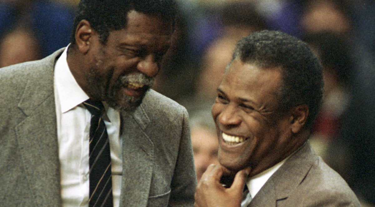 In this Jan. 15, 1988, file photo, former Boston Celtics teammates Bill Russell, Sacramento Kings coach, left, and K.C. Jones, Celtics coach, meet before the start of the Kings-Celtics NBA basketball game at the Boston Garden in Boston.