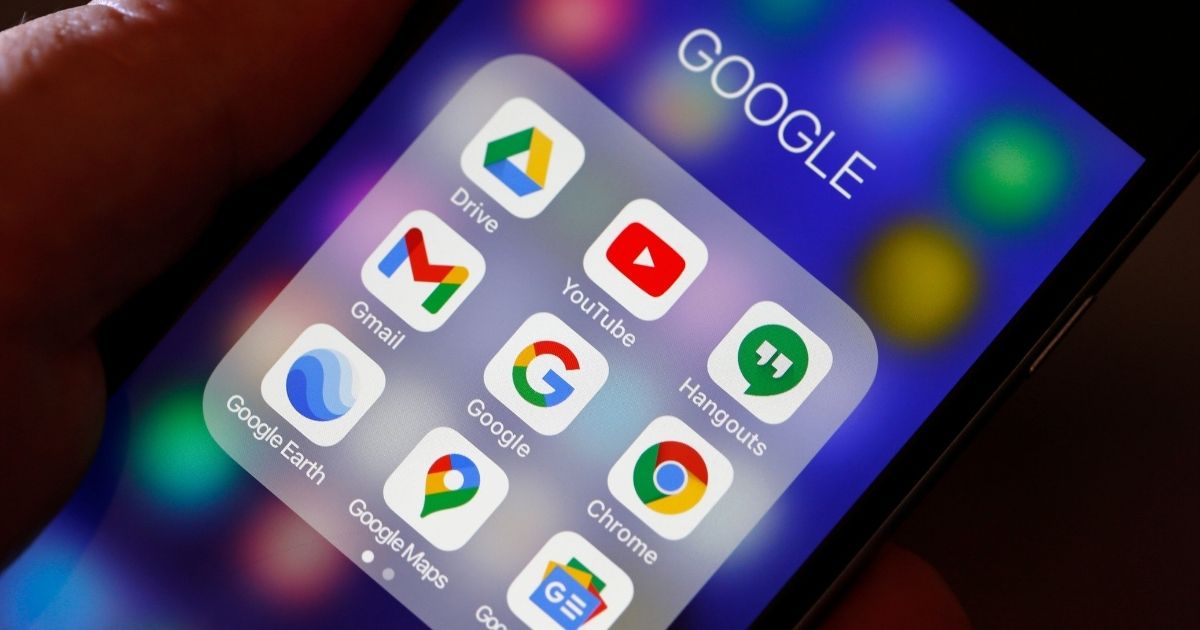 The logos of Google applications are displayed on the screen of an iPhone on Dec. 14, 2020, in Paris.