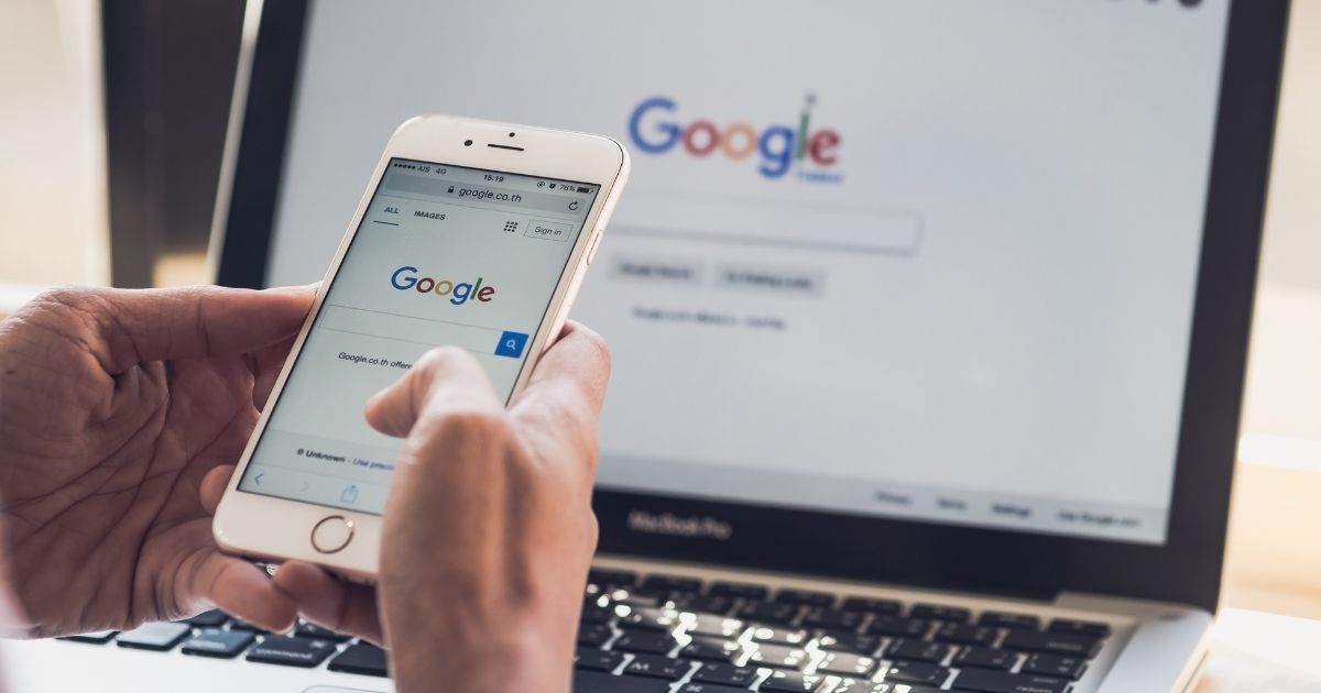 A person uses a Google application on a smartphone in this stock image.