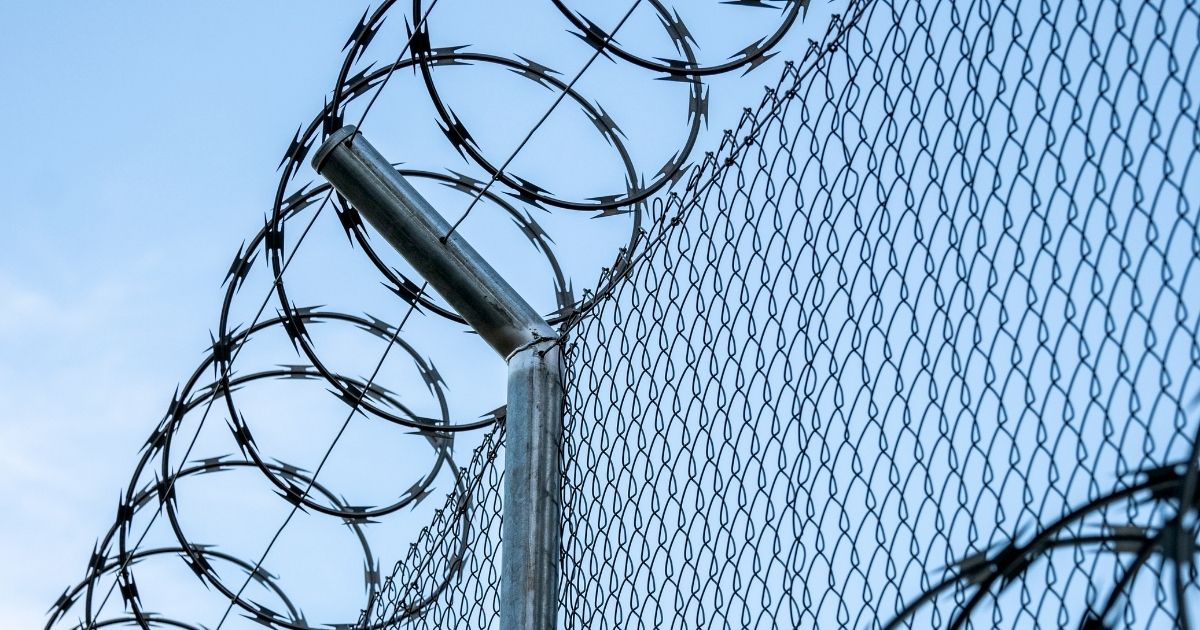 A barbed wire fence is seen in the above stock image.