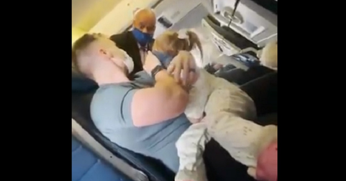 A flight attendant asks a family to leave a United Airlines flight.