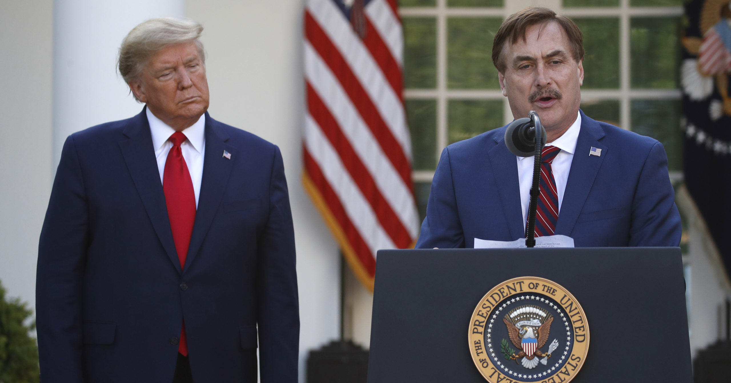 MyPillow CEO Mike Lindell speaks as President Donald Trump listens during a briefing in the Rose Garden of the White House in Washington, D.C., on March 30, 2020.