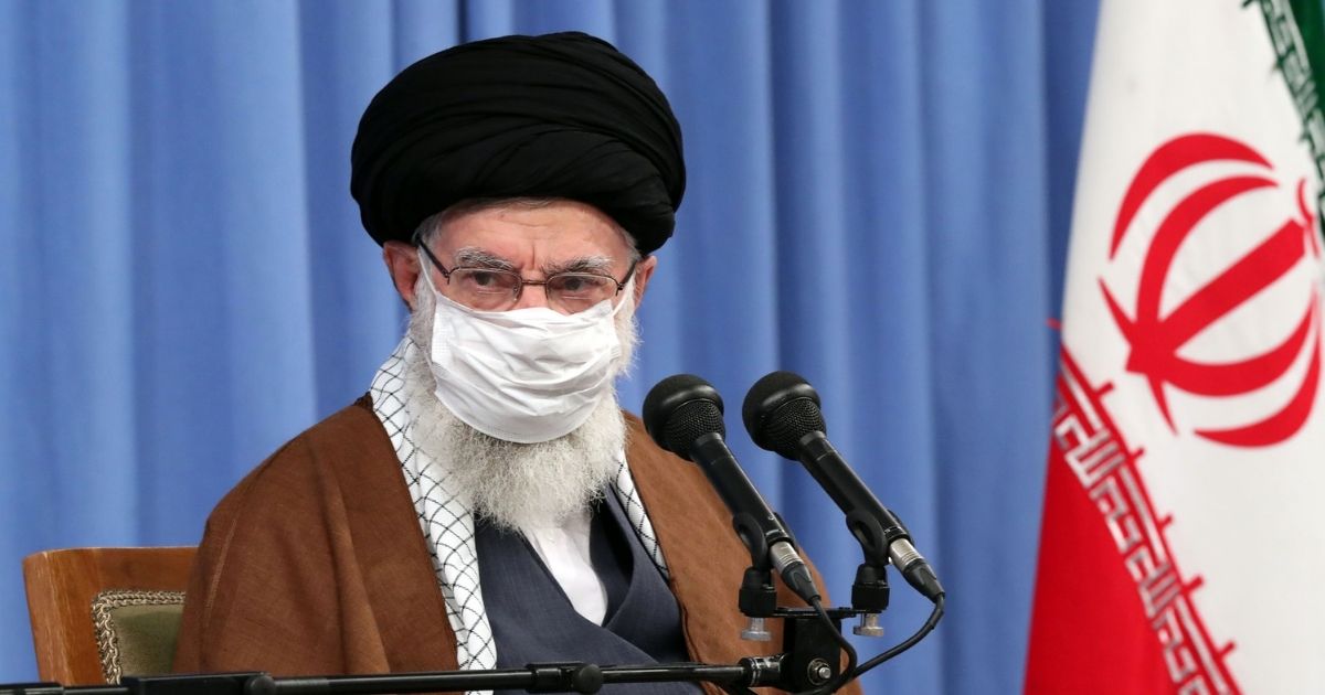 A handout picture provided by the office of Iran's Supreme Leader Ayatollah Ali Khamenei on Oct. 24, 2020, shows him wearing a protective face mask as he gives a speech in Tehran during a meeting of the national staff to discuss the COVID-19 pandemic.