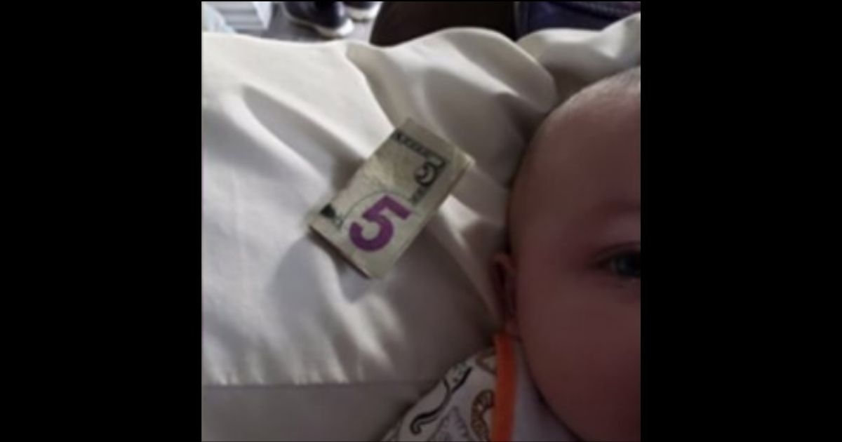 The $5 bill the Banks found under the lid of a container of formula, and their 7-month-old baby.