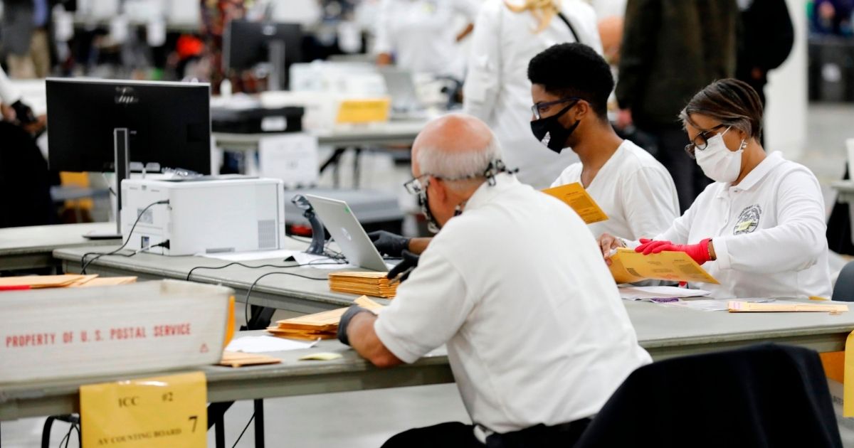 Detroit election workers work on counting absentee ballots for the 2020 general election at TCF Center on Nov. 4, 2020, in Detroit, Michigan.