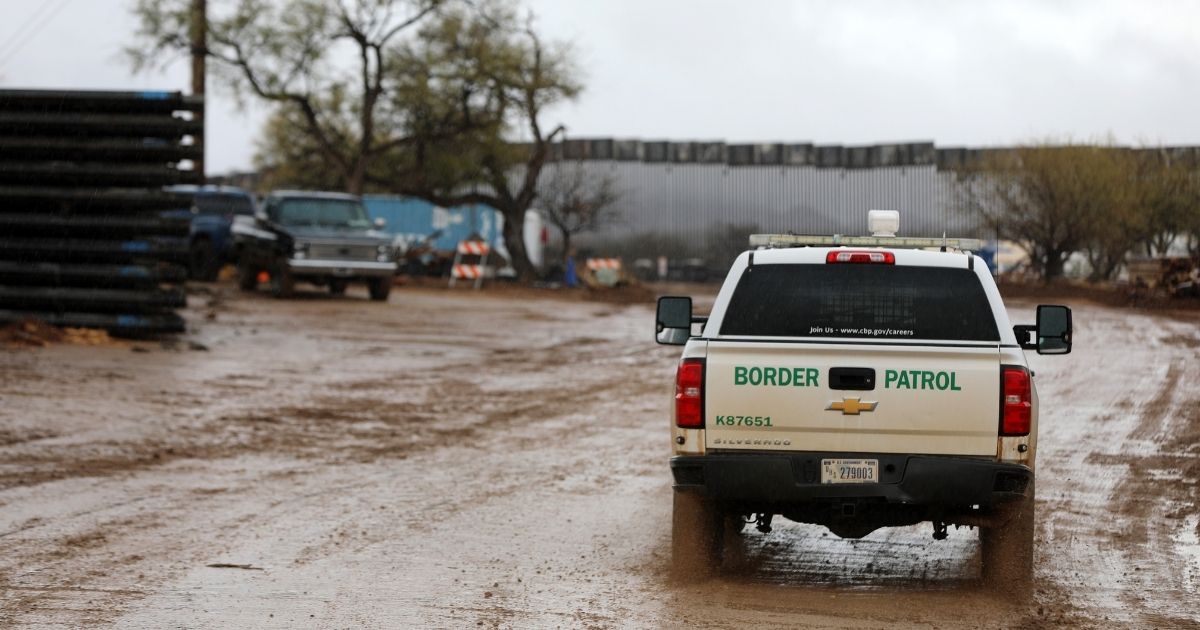 Workers move sections of the border wall on Thursday in Sasabe, Arizona.