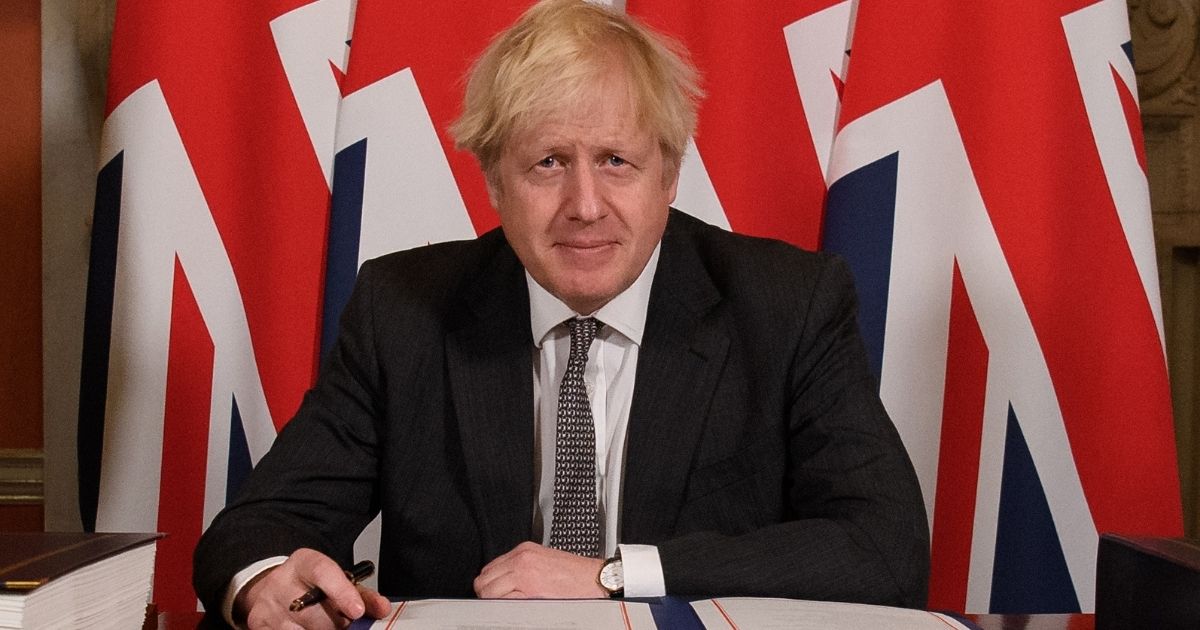 Britain’s Prime Minister Boris Johnson poses for photographs after signing the Trade and Cooperation Agreement between the U.K. and the EU, the Brexit trade deal, at 10 Downing Street in central London on Wednesday.