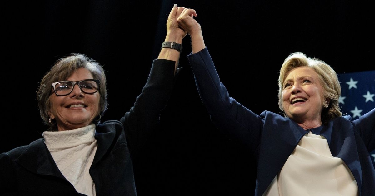 Then-Sen. Barbara Boxer of California joins hands with Hillary Clinton during a fundraiser for the Democratic presidential nominee at the Civic Center Auditorium in San Francisco on Oct. 13, 2016.