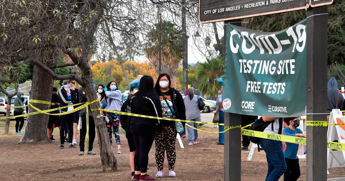 People wait in line at a COVID-19 testing center in Los Angeles on Dec. 8, 2020.