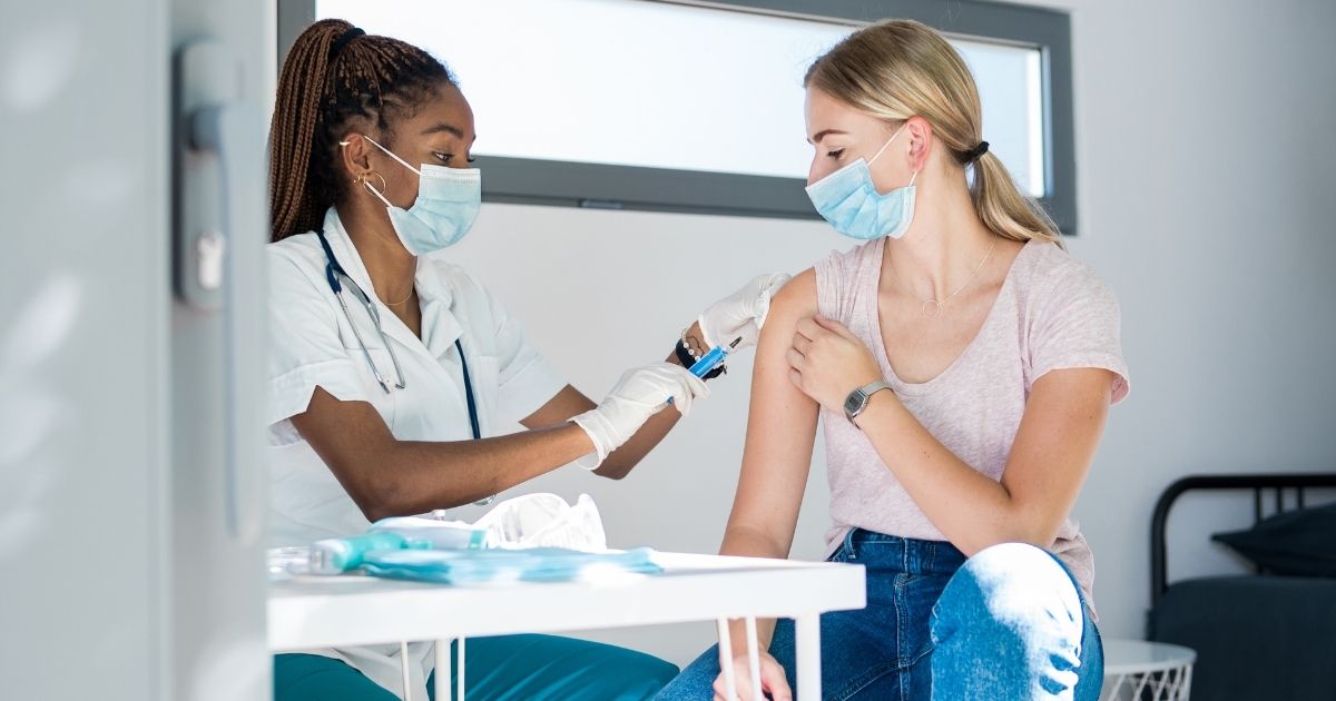 The above stock image shows a woman getting the COVID-19 vaccine.