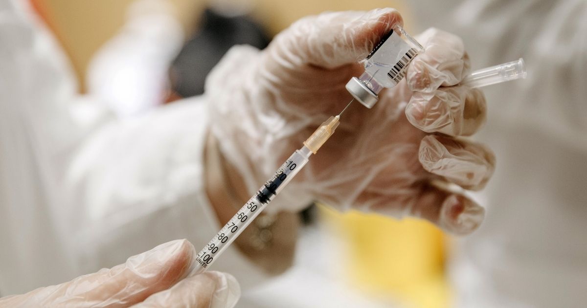 A medical worker prepares a Pfizer-BioNTech COVID-19 vaccine at a clinic in Belgrade, Serbia, on Wednesday.