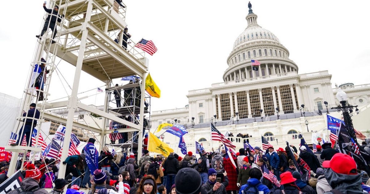 Supporters loyal to President Donald Trump clash with authorities before successfully breaching the Capitol building during a riot on the grounds Wednesday.