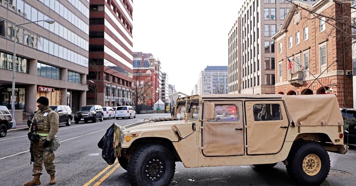 A member of the National Guard stands at a road block on 13th Street NW on Saturday in Washington, D.C.