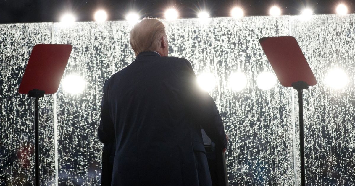 President Donald Trump speaks in the rain behind glass during an Independence Day celebration in front of the Lincoln Memorial on July 4, 2019, in Washington.
